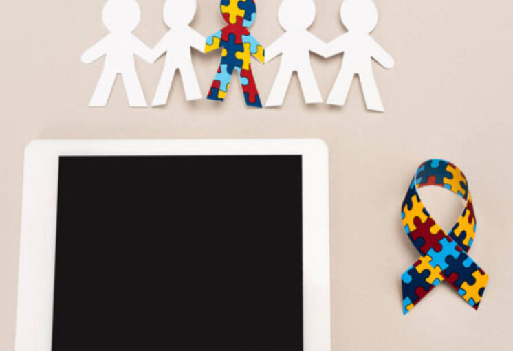Silhouettes humaines avec puzzle central, ruban arc-en-ciel et tablette, symbolisant l'inclusion et l'autisme.