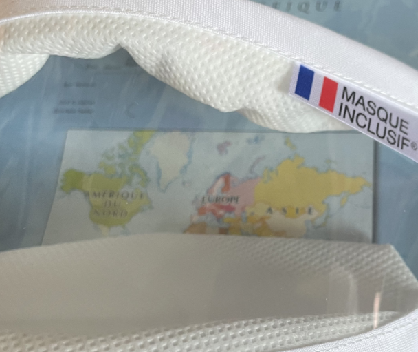 Poche à masque aéronautique avec carte du monde et étiquette française indiquant 'masque inclus'.