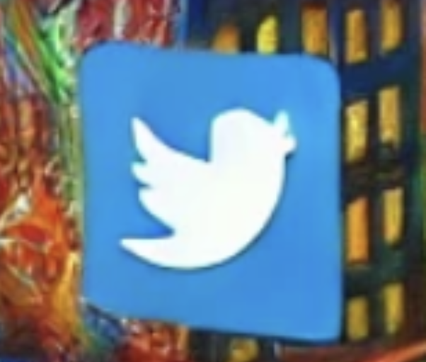 Logo bleu de Twitter sur fond coloré et texturé.